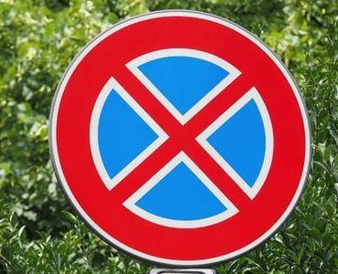 Stellplatz für den Umzugswagen Rundes Halteverbotsschild vor grünem Laub – Stellplatz für den Umzugswagen